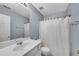 Bathroom featuring single sink vanity, a large mirror, shower with white curtain, and light blue walls at 111 Riverstone Commons Cir, Canton, GA 30114