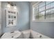 Powder room features a pedestal sink, toilet, and window for natural light and ventilation at 111 Riverstone Commons Cir, Canton, GA 30114