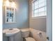 Powder room featuring a pedestal sink and natural lighting from a window at 111 Riverstone Commons Cir, Canton, GA 30114