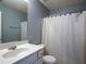 Well-lit bathroom with a white vanity, framed mirror, and white shower curtain at 111 Riverstone Commons Cir, Canton, GA 30114