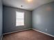 Cozy bedroom featuring neutral gray walls and a window for natural light at 111 Riverstone Commons Cir, Canton, GA 30114