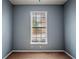 Simple bedroom with neutral walls, carpet flooring, and a single window at 111 Riverstone Commons Cir, Canton, GA 30114
