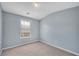 Bedroom showcasing neutral carpet, light blue walls, a window with curtains, and ample natural light at 111 Riverstone Commons Cir, Canton, GA 30114
