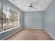 Neutral-toned bedroom with large window, ceiling fan, and ample natural light at 111 Riverstone Commons Cir, Canton, GA 30114