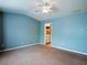 Spacious bedroom with soft carpet and blue walls, featuring a view into the ensuite bathroom at 111 Riverstone Commons Cir, Canton, GA 30114