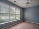 Neutral bedroom featuring carpet flooring, a ceiling fan, and large windows at 111 Riverstone Commons Cir, Canton, GA 30114