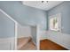 Entryway features staircase, hardwood floors, and white trim, offering a glimpse of the upper level at 111 Riverstone Commons Cir, Canton, GA 30114