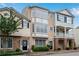 Charming townhome featuring a unique bay window design and inviting curb appeal with mature landscaping at 111 Riverstone Commons Cir, Canton, GA 30114