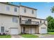 Townhome showing a two-level wood deck with garages on the ground level and a driveway at 111 Riverstone Commons Cir, Canton, GA 30114