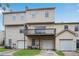 Townhome showing a two-level wood deck with garages on the ground level and a driveway at 111 Riverstone Commons Cir, Canton, GA 30114