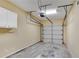 This is a two car garage, with speckled floors, white door, and visible hardware at 111 Riverstone Commons Cir, Canton, GA 30114