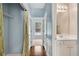 Hallway featuring hardwood floors, leading to a bathroom and bedroom at 111 Riverstone Commons Cir, Canton, GA 30114