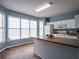 Kitchen features an island, white cabinets, and lots of natural light from the large windows at 111 Riverstone Commons Cir, Canton, GA 30114