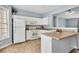 Bright kitchen with white cabinetry, island, and large window at 111 Riverstone Commons Cir, Canton, GA 30114