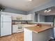 Kitchen featuring white cabinets, a breakfast bar, and modern appliances at 111 Riverstone Commons Cir, Canton, GA 30114