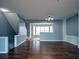 Living room showcasing hardwood floors and an open staircase at 111 Riverstone Commons Cir, Canton, GA 30114