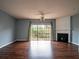 Living room featuring hardwood floors, a fireplace, and large windows at 111 Riverstone Commons Cir, Canton, GA 30114