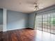 Bright living room with hardwood floors, blue walls, and sliding doors to the deck at 111 Riverstone Commons Cir, Canton, GA 30114