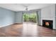 Spacious living room with fireplace, wood floors, and sliding glass doors to a patio at 111 Riverstone Commons Cir, Canton, GA 30114