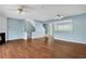 Open concept living room with fireplace, wood floors, and staircase at 111 Riverstone Commons Cir, Canton, GA 30114