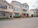 Street view of charming townhomes featuring diverse facades and neatly kept landscaping at 111 Riverstone Commons Cir, Canton, GA 30114