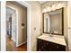 Cozy half-bathroom features modern vanity, sink, and mirror with lighting fixture at 1460 Edgemont Pt, Lawrenceville, GA 30044