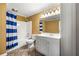 Bright bathroom featuring a shower-tub combo, white vanity with storage, and neutral tile flooring at 1460 Edgemont Pt, Lawrenceville, GA 30044