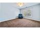 This empty bedroom is well-lit and features carpet, light blue walls and a chair at 1460 Edgemont Pt, Lawrenceville, GA 30044