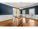 Elegant dining room with hardwood floors, wainscoting, and a modern chandelier at 1460 Edgemont Pt, Lawrenceville, GA 30044