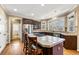 Gourmet kitchen with granite countertops, stainless steel appliances, and a central island with seating at 1460 Edgemont Pt, Lawrenceville, GA 30044
