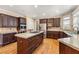 Beautiful kitchen with custom cabinets, stainless appliances, and a functional center island with a cooktop at 1460 Edgemont Pt, Lawrenceville, GA 30044