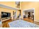 Open-concept living room features a staircase, hardwood floors, and seamless flow to the adjacent rooms at 1460 Edgemont Pt, Lawrenceville, GA 30044