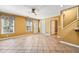 Open concept living room featuring ceramic tile floors, a ceiling fan, and two large windows at 1460 Edgemont Pt, Lawrenceville, GA 30044