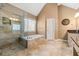 The main bathroom featuring double sinks, a soaking tub, and a glass enclosed shower at 1460 Edgemont Pt, Lawrenceville, GA 30044