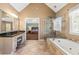 This large main bathroom features double sinks, a soaking tub and glass enclosed shower at 1460 Edgemont Pt, Lawrenceville, GA 30044