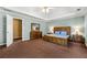 View of the main bedroom offering neutral wall color and a rustic wooden bed set at 1460 Edgemont Pt, Lawrenceville, GA 30044