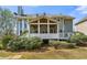 Rear exterior of a two-story home featuring a screened-in porch with stairs to the yard at 1460 Edgemont Pt, Lawrenceville, GA 30044