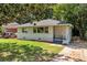 Charming, one story home with a well-maintained lawn and a driveway leading to the house at 732 Quaker Sw St, Atlanta, GA 30315