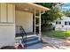 Close up of a freshly painted front porch with black railings and a gray staircase leading to the front door at 732 Quaker Sw St, Atlanta, GA 30315