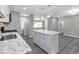 Open-concept kitchen boasts a center island with marble countertop and modern pendant lighting at 732 Quaker Sw St, Atlanta, GA 30315