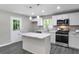 Modern kitchen featuring stainless steel appliances, a marble countertop island, and new cabinetry at 732 Quaker Sw St, Atlanta, GA 30315