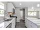 Bright kitchen features white cabinets, stainless steel appliances, and marble countertops with an island at 732 Quaker Sw St, Atlanta, GA 30315