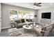 Cozy living room featuring a large window with a view of the outdoors and neutral furniture at 732 Quaker Sw St, Atlanta, GA 30315