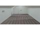Finished attic area with gray carpet, white walls, and trim and a modern door at 1956 Washington Rd, East Point, GA 30344