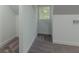 Attic space with plush gray carpet, white walls and small window at 1956 Washington Rd, East Point, GA 30344