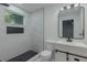 Newly remodeled bathroom with black hexagon tile floor, shower niche, and large mirror at 1956 Washington Rd, East Point, GA 30344