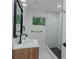 Modern bathroom with black framed mirror, marble tile, and walk in shower at 1956 Washington Rd, East Point, GA 30344