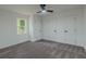 Bright bedroom features plush gray carpet, a modern ceiling fan, and three white doors at 1956 Washington Rd, East Point, GA 30344