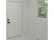 Bright interior view with a white door, modern black hardware, and a sun-filled window at 1956 Washington Rd, East Point, GA 30344