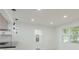 Bright living room area with modern light fixtures and lots of windows at 1956 Washington Rd, East Point, GA 30344